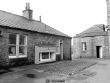 Glenugie Distillery View from NE showing weighbridge and NNW front of associated building with building on W side of courtyard in background by JR Hume 1977 copyright RCAHMS.jpg